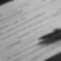 A close-up of a car title document with a pen